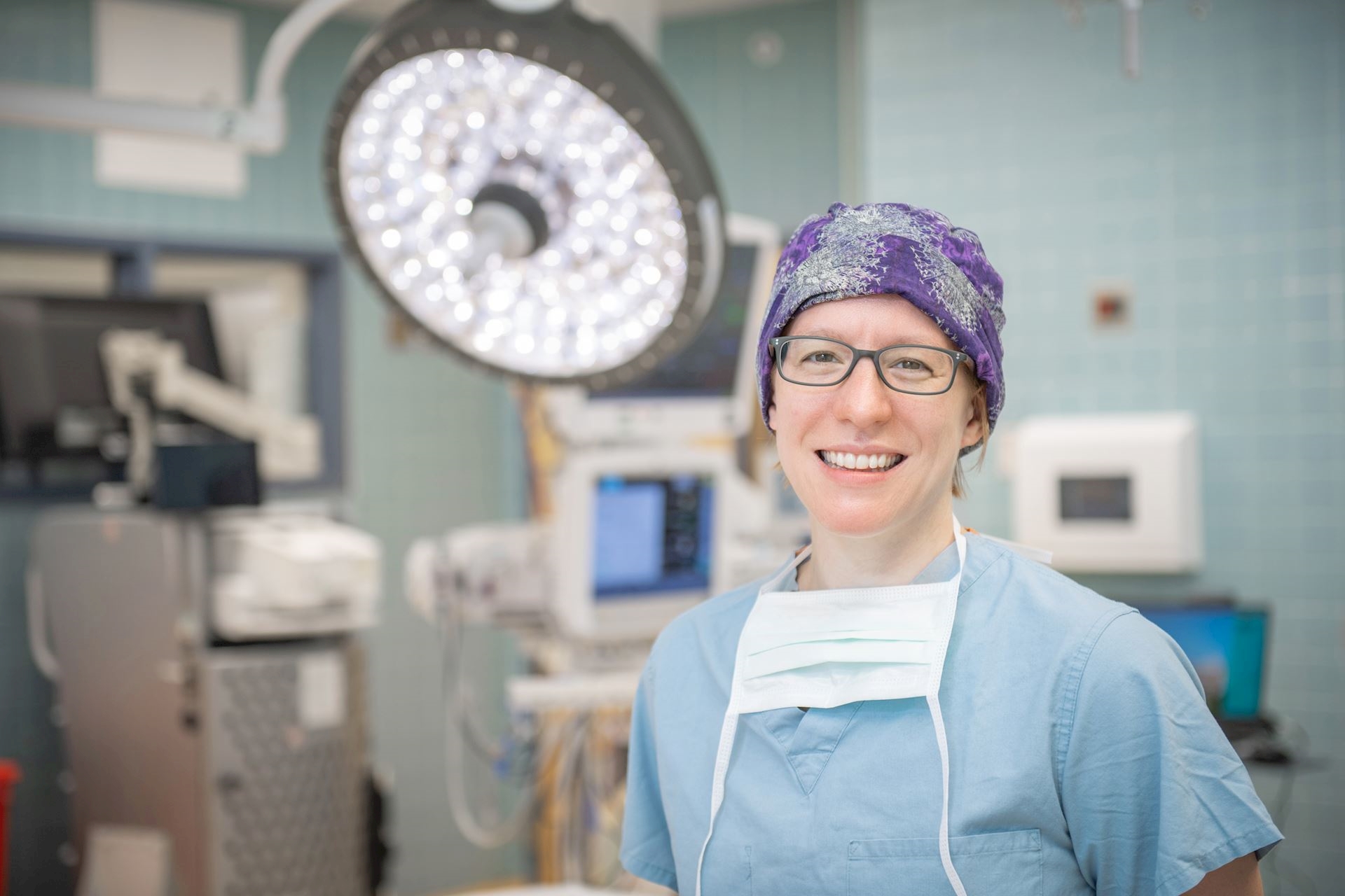 Dr. Riley in a surgical gown and mask